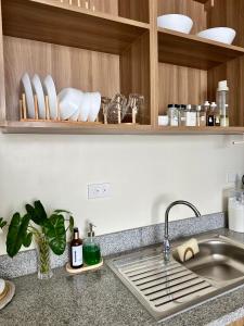 a kitchen with a sink and a counter top at Mactan Plains Residences in Mactan +5 photos