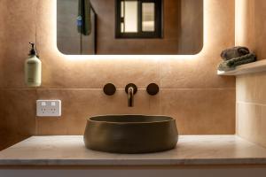 a bathroom with a sink and a mirror at Pacific Sun Bargara in Bargara