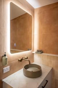 a bathroom with a sink with a large mirror at Pacific Sun Bargara in Bargara