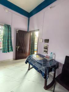 a room with a table in a room with a door at Makum Homestay in Mākum
