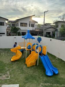 a child playing on a playground in a yard at Mactan Plains Residences in Mactan
