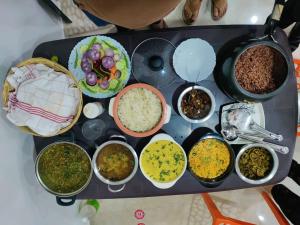 a table with different types of food on it at Decent Stays Rooms and Apartments in Shimla