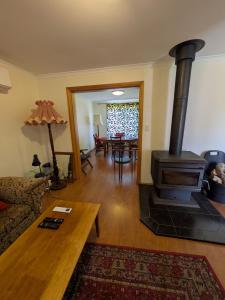 a living room with a wood stove in a room at Swallows Nest in Cape Bridgewater