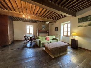a living room with a couch and a table at Maison poumarou in Sainte-Colome