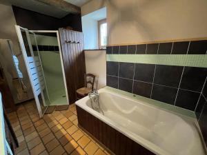 a bathroom with a large tub and a shower at Maison poumarou in Sainte-Colome +30 photos