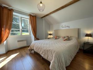 a bedroom with a bed and a large window at Peyre in Aramits