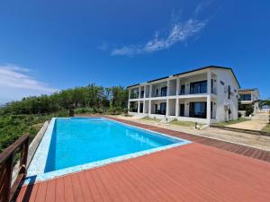an image of a house with a swimming pool at Golden Palm Apartment with overlooking view in Port Vila