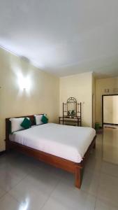 a bedroom with a large bed in a room at Homely Guest House Tegal in Tegal