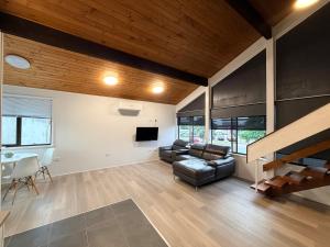 a living room with a couch and a table at Pacific Motel Taree in Taree