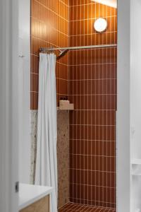 a shower with a white shower curtain in a bathroom at Newly Remodeled Bayview Cabin 6! in Traverse City +59 photos