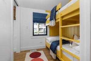 a small bedroom with bunk beds and a window at Newly Remodeled Bayview Cabin 6! in Traverse City