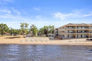 a beach with chairs and a building at Newly Remodeled Bayview Cabin 6! in Traverse City