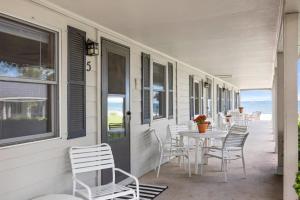 a patio with a table and chairs on a house at Topico Cabin 5 . Topico Cabin 5 in Traverse City
