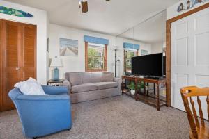 a living room with a couch and a television at Topico Cabin 5 . Topico Cabin 5 in Traverse City