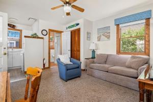 a living room with a couch and a chair at Topico Cabin 5 . Topico Cabin 5 in Traverse City +34 photos