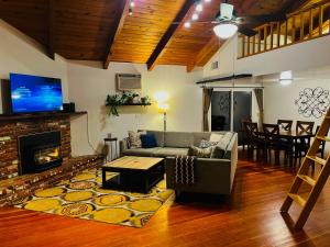a living room with a couch and a fireplace at Riverfront with EV charger - Sequoia River Cottage in Three Rivers