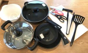 a table with a frying pan and other kitchen utensils at MEIBI Hakone Yumoto in Hakone