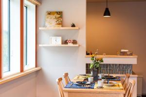 a dining room with a table and chairs at MEIBI Hakone Yumoto in Hakone