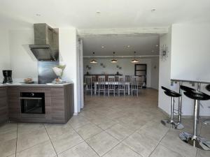 a kitchen and living room with a table and chairs at Gite du coos in Audaux