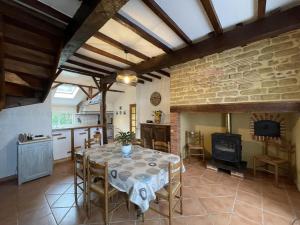 a kitchen and dining room with a table and a fireplace at Chez file in Séméacq-Blachon