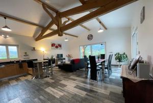 a living room with a dining room and a living room with a table at Eki-begia in Ainhice-Mongelos