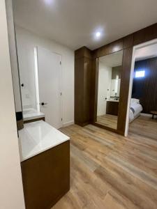 an empty room with a large mirror and a bedroom at Bello Departamento in Mexicali