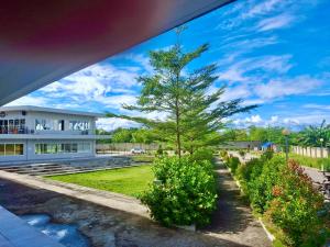 a house with a tree in front of it at PG Vacation Rental in Lapu Lapu City