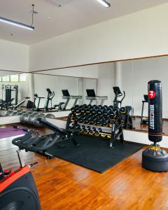 a gym with treadmills and machines in a room at Amayi Resort Nusa Dua in Nusa Dua