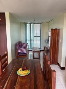 a table with a plate of fruit on top of it at PG Vacation Rental in Lapu Lapu City