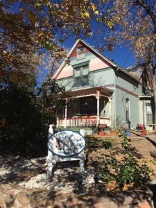 a house with a sign in front of it at The Silk Pincushion in Golden