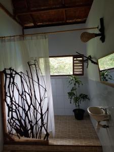 a bathroom with a shower and a sink at Batu Kapal Guest House & Jungle trekking in Bukit Lawang