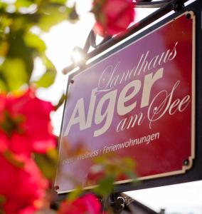 a sign that reads antioch albert amice in front of flowers at Landhaus Alger in Immenstadt im Allgäu