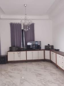 a living room with a chandelier in the middle at Mroom Villa Cipanas in Pacet +6 photos