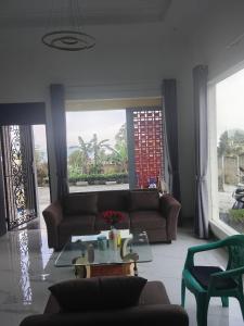 a living room with a couch and a table at Mroom Villa Cipanas in Pacet
