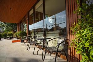 a row of tables and chairs outside of a building at VELIN Pattaya Hotel in Pattaya +45 photos