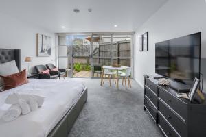 a bedroom with a large bed and a living room at Bay View Sunrise in Lorne