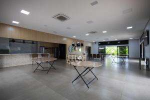 a lobby with tables and chairs and a counter at Espaço JF in Aparecida de Goiânia