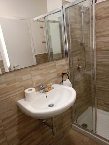 a bathroom with a sink and a shower at Fabian Appartament in Bagheria