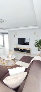 a living room with a couch and a tv at The Haven in Nelspruit