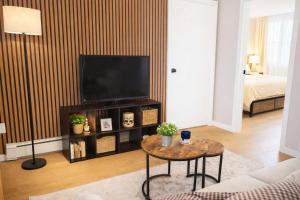 a living room with a television and a coffee table at Jefferson Sr - 20 mins to Manhattan, NYC in West New York