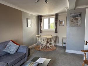a living room with a couch and a table at Greenmantle in Skinburness