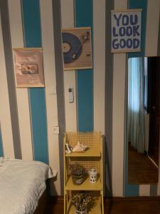 a bedroom with blue and white stripes and a bed at Green Rooms in Batumi