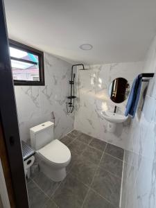 a bathroom with a toilet and a sink at 5BR Private Pool in Jomtien Beach +11 photos