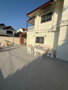 a white bench sitting outside of a building at 5BR Private Pool in Jomtien Beach