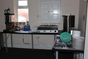 a kitchen with a counter top with dishes on it at The Premier Lodge in Morpeth