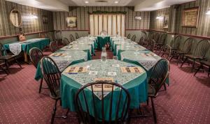 a conference room with long tables and chairs at The Globe Inn in East Greenville