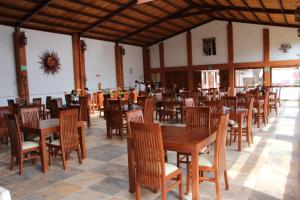 comedor con mesas y sillas de madera en La Capilla Hotel Boutique en Valle de Bravo