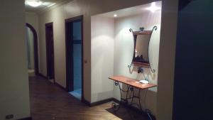 a dressing room with a vanity and a mirror on a wall at Maadi International Center Apartments in Cairo