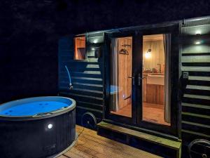 a small bathroom with a tub and a sink at Coastal Views in Cloughton +4 photos