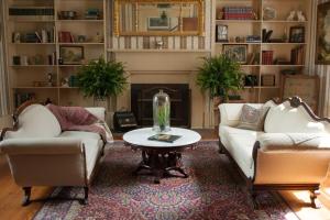 a living room with two couches and a table at The Denny House in Paint Lick